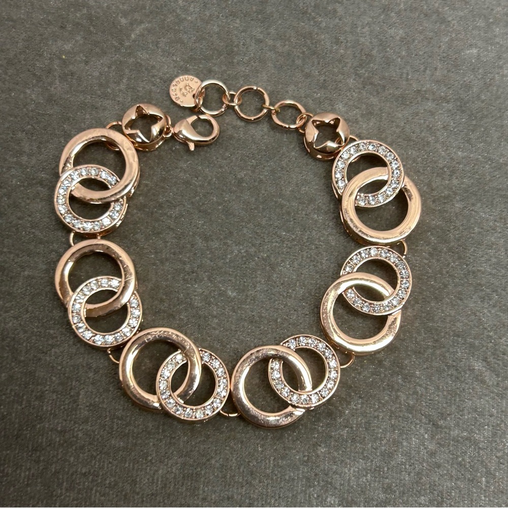 Absolute rose gold tone circular interlocking chain-link rhinestone bracelet